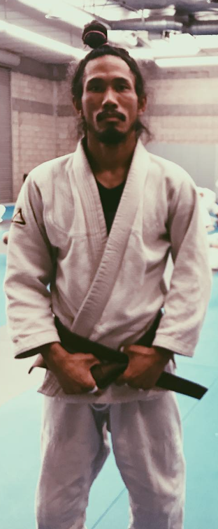 Jason Cruz in his gi, wearing the black belt he received from Rickson Gracie